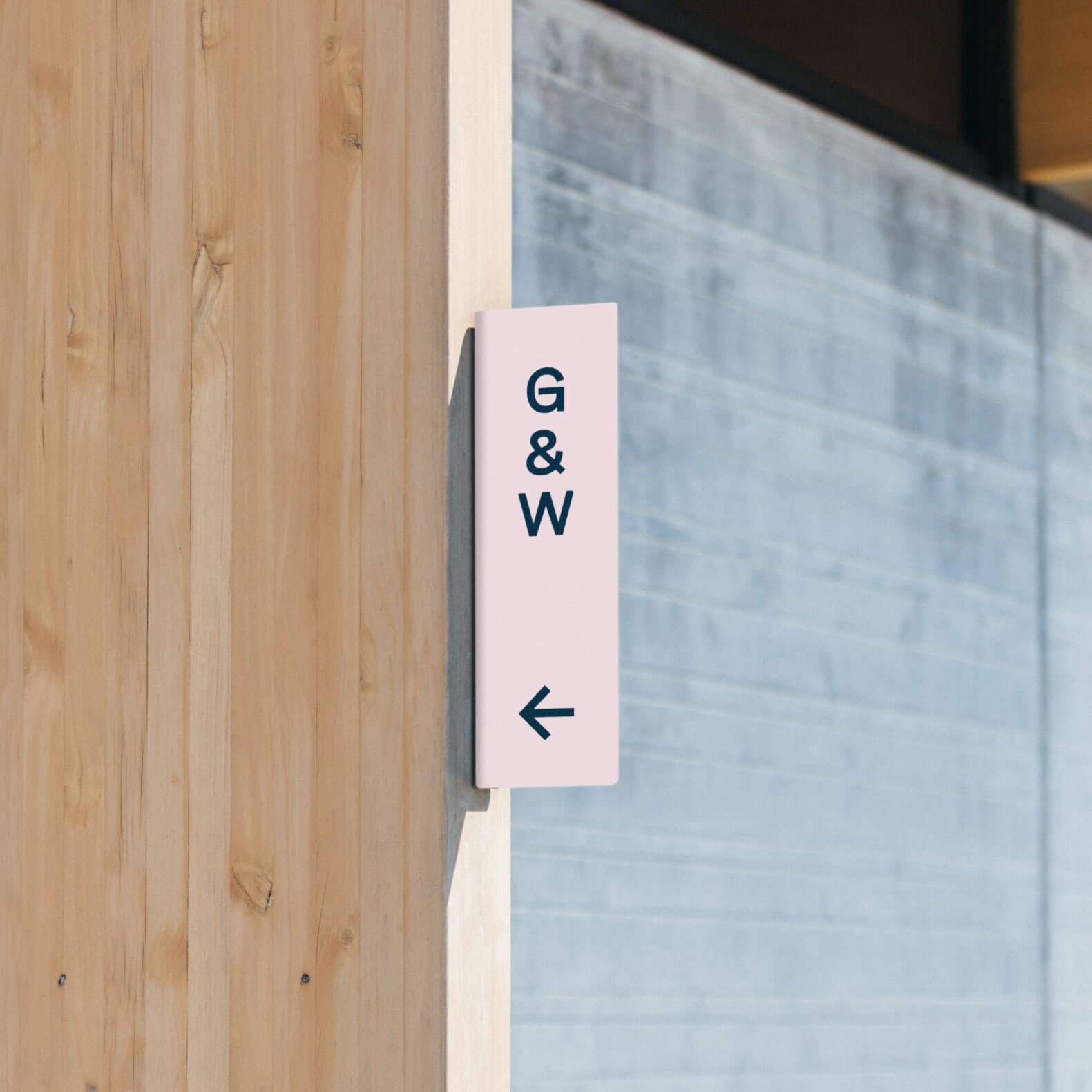 pink colored wayfinding wall sign with custom branding