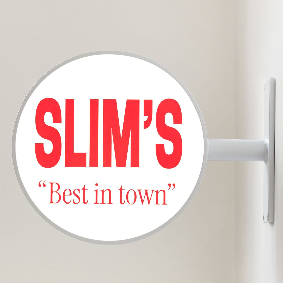 round illuminated lightbox sign showing the company "Slim's" branding