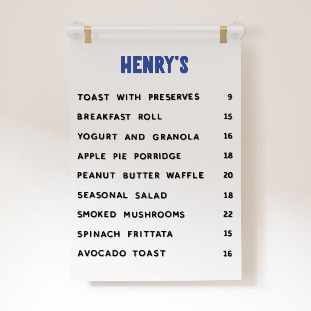 white hanging cafe menu signage with brass hooks