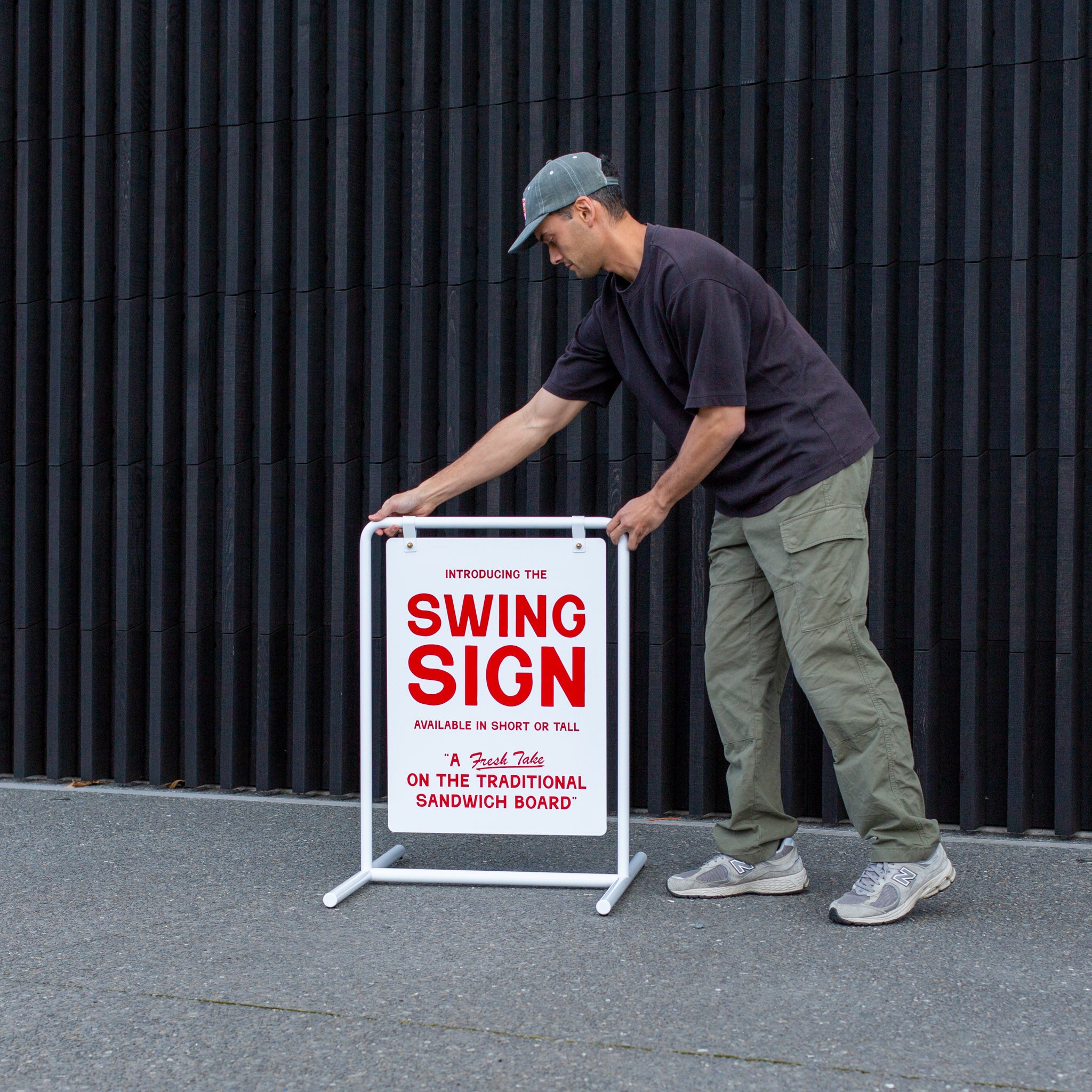 standing sidewalk customisable swing sign being put out on sidewalk by human